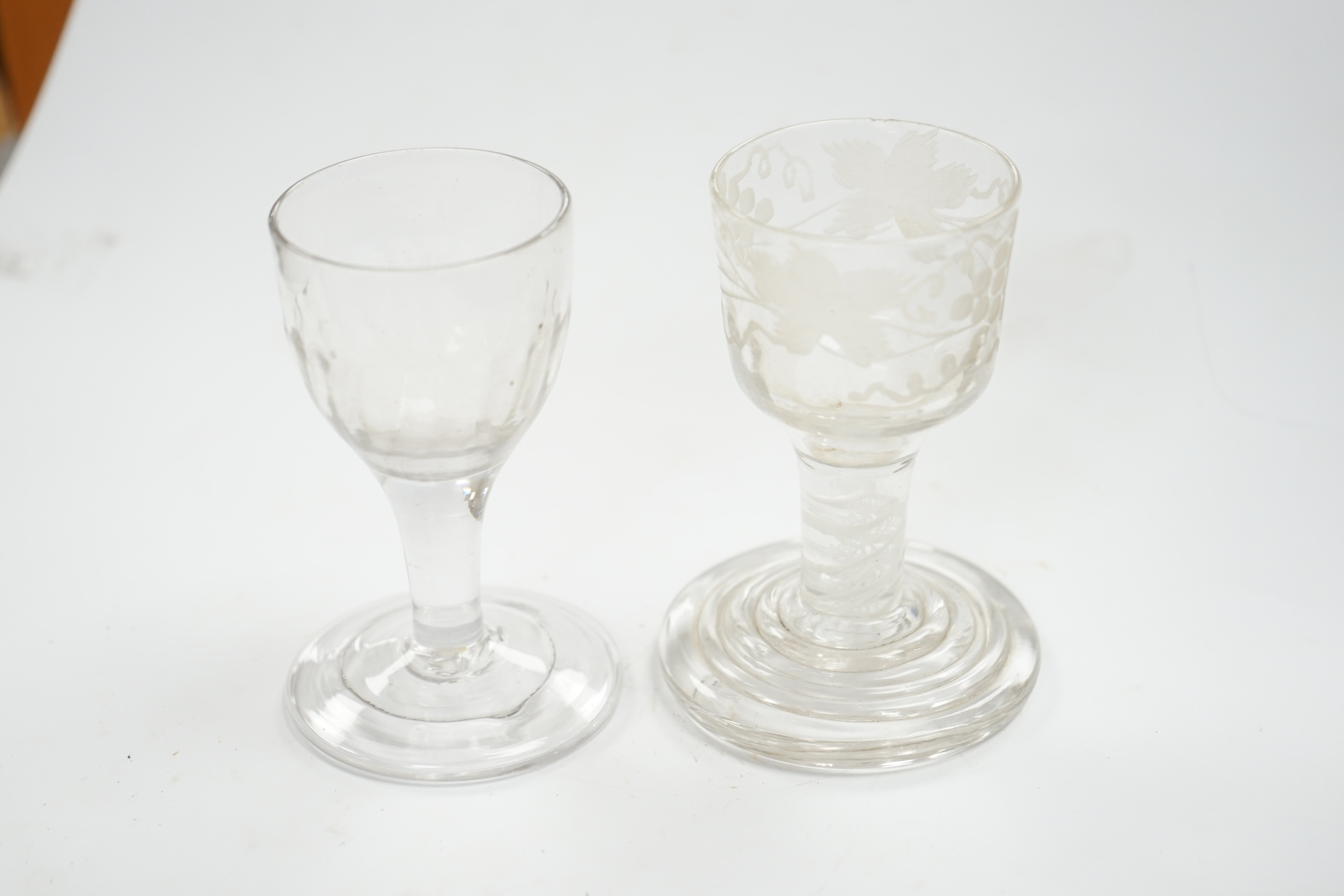 A mid 18th century firing glass with double series opaque twist stem and terraced foot, and another glass, tallest 9.5cm high. Condition - good